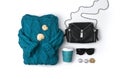 Flat lay top view turquoise sweater, purse, sunglasses, dry leaves and coffee on white background Royalty Free Stock Photo