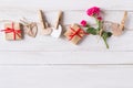 Flat lay, top view Valentines Day background with twine, wooden hears, rose, gifts