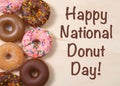 Donuts on table with Happy National Donut Day text