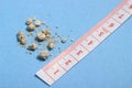 Flat lay or top view very small kidney stones with ruler at blue background Royalty Free Stock Photo