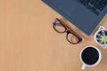 Flat lay, Top view work space in office.  with laptop, Glasses, white coffee cup on wooden Table. Royalty Free Stock Photo