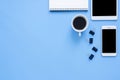 Flat lay top view of a working space with white blank notebook page, plant tree and mock up phone on pastel background. Royalty Free Stock Photo