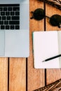 Flat lay, top view of the workspace with a laptop, on a brown wooden table with a notebook for recording cases. Remote work. wood Royalty Free Stock Photo