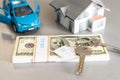 flat lay toy car, toy house, keys and money on the table Royalty Free Stock Photo