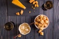 Flat lay. Traditional french cheese fondue. Crouton dipped into hot cheese fondue on a long-stemmed fork. Royalty Free Stock Photo