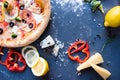 Flat lay with traditional Italian pizza with salmon, broccoli and philadelphia cheese on black stone table Royalty Free Stock Photo