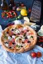 Flat lay with traditional Italian pizza with salmon, broccoli and philadelphia cheese on black stone table Royalty Free Stock Photo