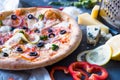 Flat lay with traditional Italian pizza with salmon, broccoli and philadelphia cheese on black stone table Royalty Free Stock Photo
