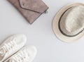 Flat lay travel items - shoes, hat and purse