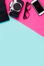 Flat lay traveler accessories on a colorful background with copy space. camera, smartphone, glasses on pink and blue Royalty Free Stock Photo