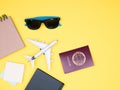 Flat lay of traveler kit on yellow background Royalty Free Stock Photo