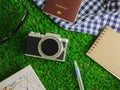 Flat lay traveling accessories on green grasses background with copy space Royalty Free Stock Photo