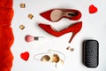 Flat lay tValentines day party outfit composition red shoes accessories jewelry clutch two hearts on white background. Party date Royalty Free Stock Photo