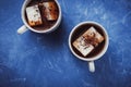 Flat lay of two cups of cocoa or hot chocolate