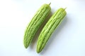 Flat lay two fresh green vegetables bitter gourd or Bitter melon isolate on a white background Royalty Free Stock Photo