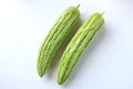 Flat lay two fresh green vegetables bitter gourd or Bitter melon isolate on a white background Royalty Free Stock Photo