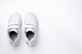 flat lay two white girl sneakers with velcro fasteners isolated on a white background