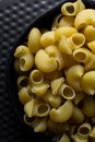 Flat lay of uncooked pipe rigate pasta, top view of pipe rigate pasta shells