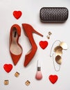 Flat lay Valentines day party outfit composition red shoes accessories jewelry clutch hearts on white background. Party date night Royalty Free Stock Photo