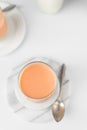 Flat lay of vanilla and orange creamsicle panna cotta, Top view of panna cotta served in a glass cup with a spoon