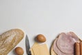 Flat lay of various ingredients for breakfast on white background, bread, egg, sausage, ham, and cheese set Royalty Free Stock Photo