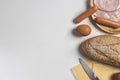 Flat lay of various ingredients for breakfast on white background, bread, egg, sausage, ham, and cheese set Royalty Free Stock Photo