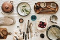 Various kitchen utensils, tablewear and fresh bread over linen tablecloth Royalty Free Stock Photo