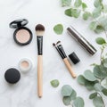 Beautiful arrangement of makeup products with brushes and eucalyptus leaves on marble surface Royalty Free Stock Photo