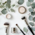 Beautiful arrangement of makeup products with brushes and eucalyptus leaves on marble surface Royalty Free Stock Photo