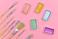 Flat lay with various metallic colorful watercolors and used dirty paint brushes on pink backgrund Royalty Free Stock Photo