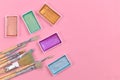 Flat lay with various metallic colorful watercolors and used dirty paint brushes on pink backgrund with  copy space Royalty Free Stock Photo