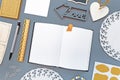 Flat lay with various neatly arranged desk with office supplies like pencils, ruler, notes, word `Love` pins and empty noteboook