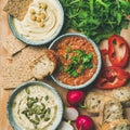 Flat-lay of Vegetarian dips hummus, babaganush, muhammara, square crop