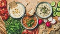 Flat-lay of Vegetarian dips hummus, babaganush, muhammara