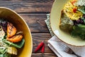 flat lay with vegetarian salads served in bowls, chili peppers and fork