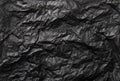 Flat lay view of black color crumpled package filling silk paper. Royalty Free Stock Photo