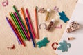 Craft station with colour pencils, bottles of beads, felt butterflies and leaf, drawing pad and wooden stamps with different motif Royalty Free Stock Photo