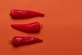 Flat lay view of hot red chili peppers. Food background. Copy space. Bright red orange background. Design banner. Royalty Free Stock Photo