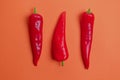 Flat lay view of hot red chili peppers. Food background. Copy space. Bright red orange background. Design banner. Royalty Free Stock Photo