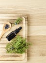 Flat lay view Juniper latin Juniperus communis berry essential oil in brown dropper bottle.