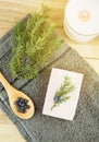 Flat lay view Juniper latin Juniperus communis berry soap bar juniper tree branch with confier cones.