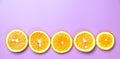 Flat lay view of orange slices on pink backround