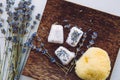 Flat lay view of small cube shape bathroom bath fizzies on wood tray. Royalty Free Stock Photo