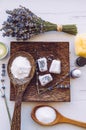 Small cube shape bathroom bath fizzies on wood tray, surrounded by ingredients. Royalty Free Stock Photo