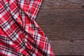 Flat lay view of tartan textured scarf on wooden background.