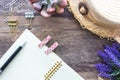 The Flat lay of vintage feminine summer concept with an open pink spiral notebook, beach hat, wooden clips and lavender Royalty Free Stock Photo