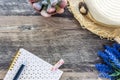 The Flat lay of vintage feminine summer concept with pink spiral notebook, beach hat and lavender. Royalty Free Stock Photo