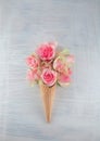 Flat lay waffle sweet ice cream cone with pink roses blossom flowers Royalty Free Stock Photo