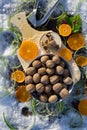 Flat lay with walnut on wooden board, cracked nut with nutshell, Nutcracker, ebony, mandarin green grass on background