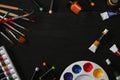 Flat lay watercolors, palette and paint brushes on black wooden table. Artist or designer workplace Royalty Free Stock Photo